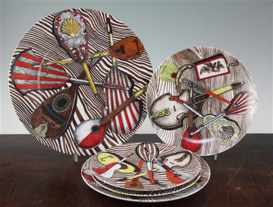 A large Fornasetti Strumenti Musicali pattern dish and four similar plates, 20.5.cm - 32cm